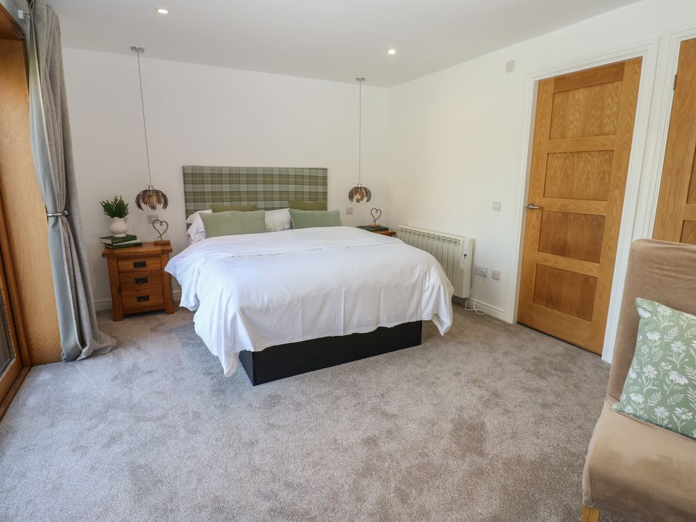 A bedroom with a bed and a bedside table at The Cart House in Snape near Bedale