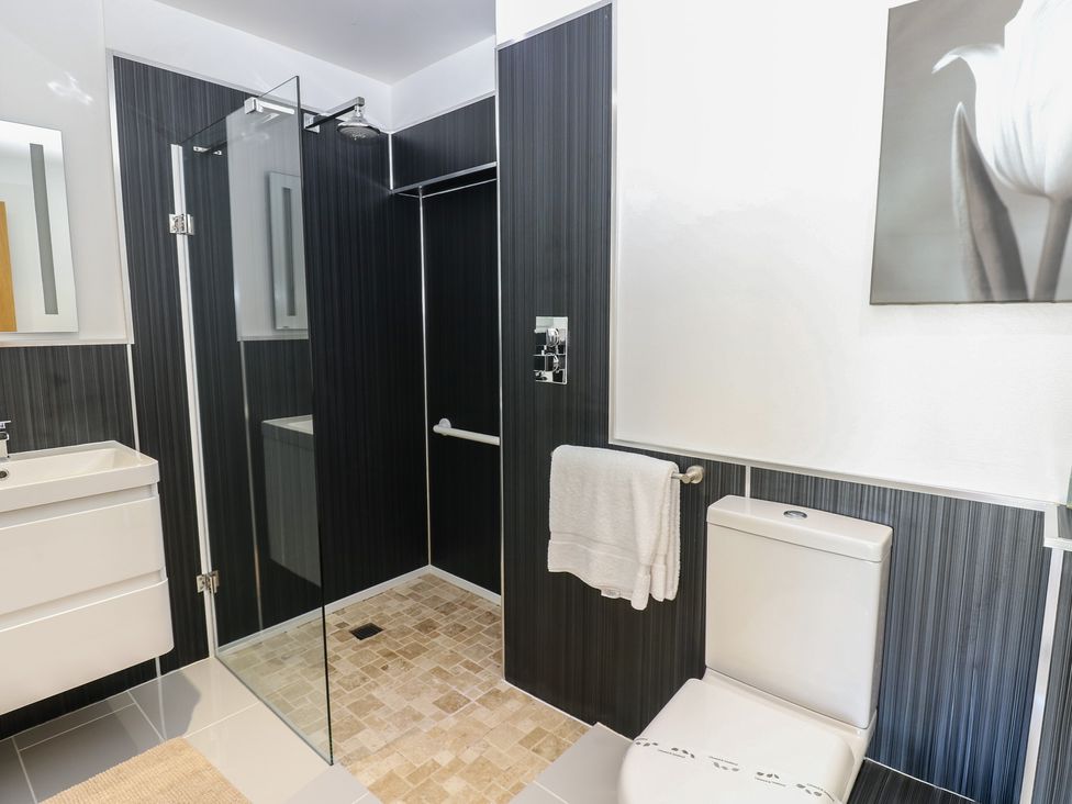 A bathroom with a shower, sink, and toilet at The Cart House in Snape near Bedale