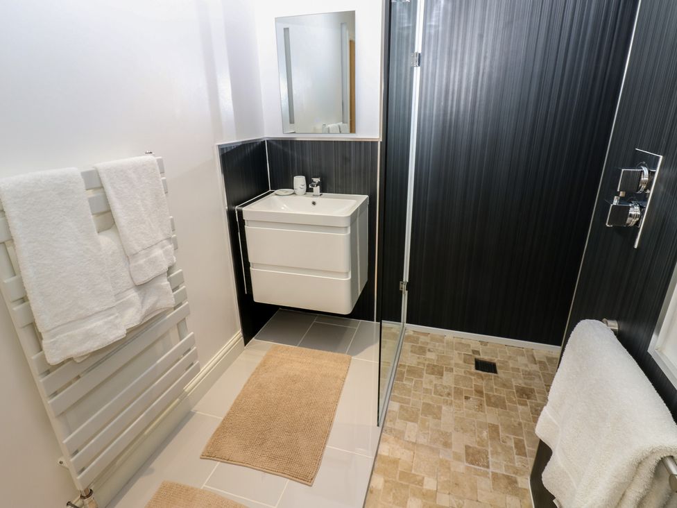 A bathroom with a shower and sink at The Cart House in Snape near Bedale
