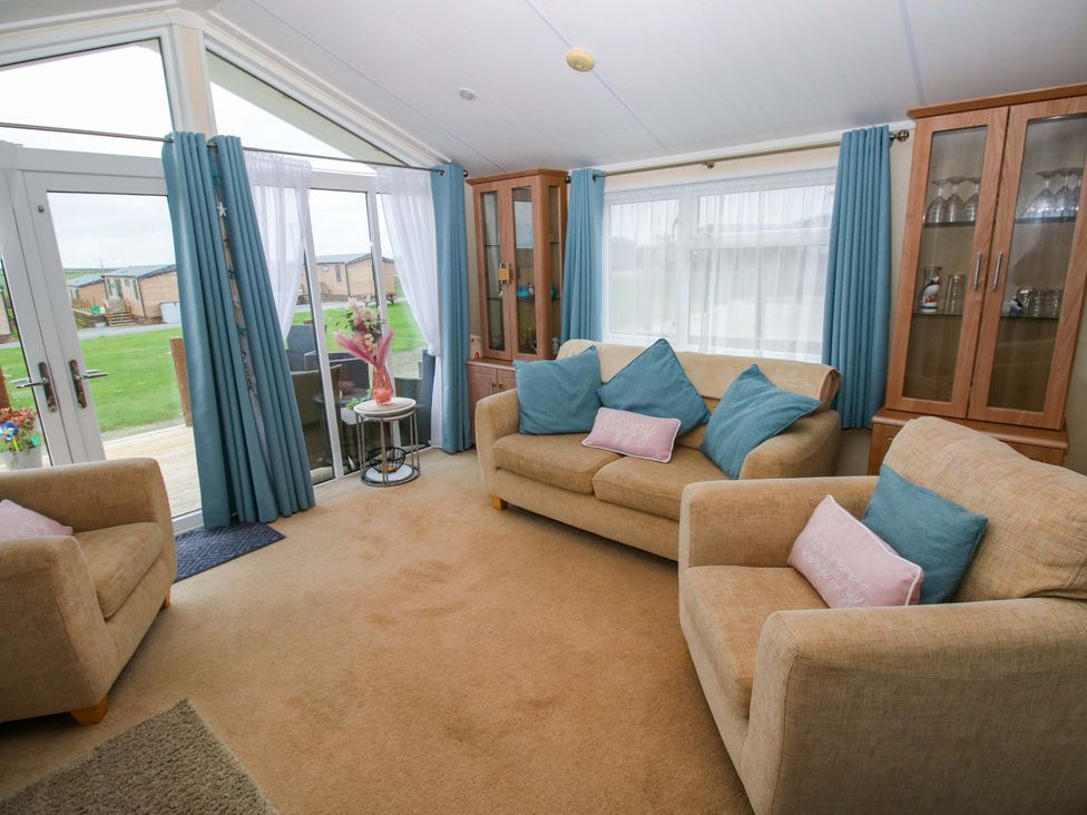 A living room with seating and a view at Gentle Tide Hasguard Cross near Little Haven