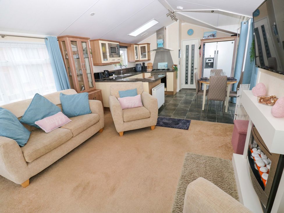 A living room with kitchen and dining area at Gentle Tide Hasguard Cross near Little Haven