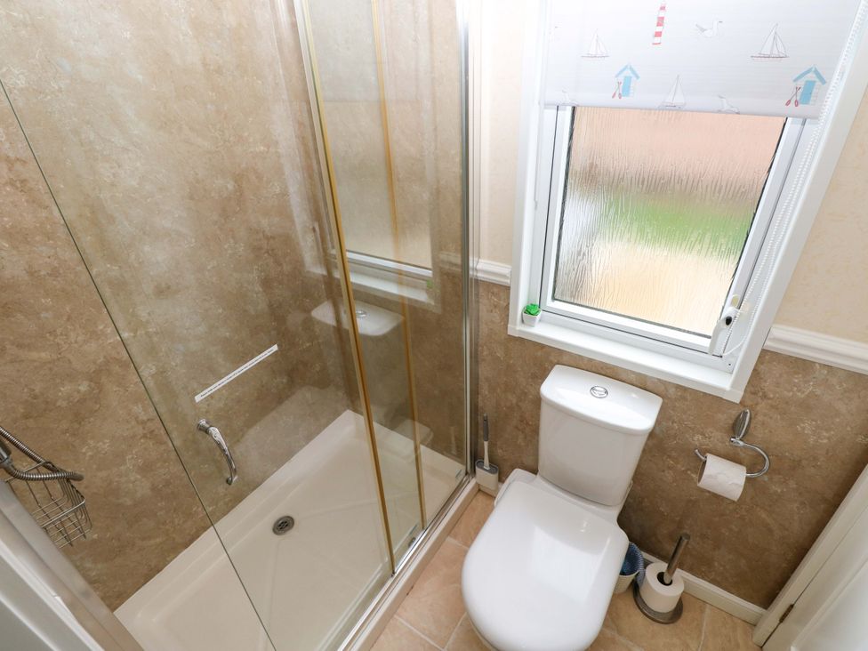 A bathroom with a shower and toilet at Gentle Tide near Hasguard Cross near Little Haven