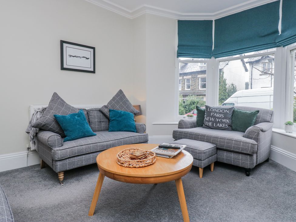 A living room with a sofa and coffee table at The Thistles in Bowness-On-Windermere