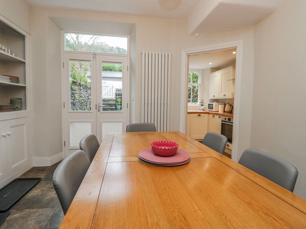 A dining room with a wooden table and chairs at The Thistles Bowness-On-Windermere