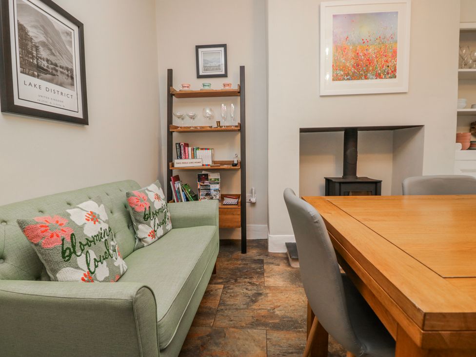 A dining room with a table and chairs at The Thistles in Bowness-On-Windermere
