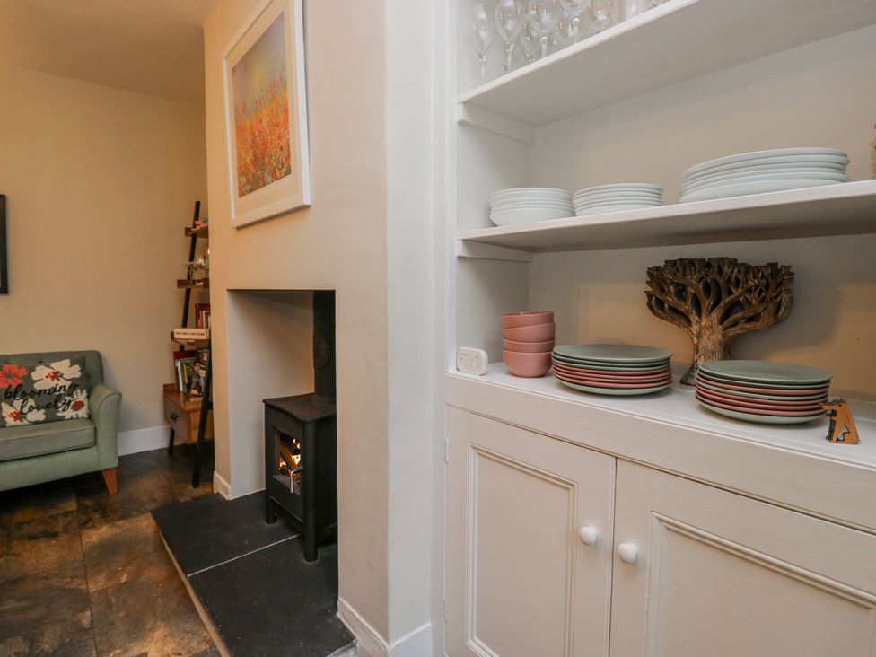 A living room with a sofa and fireplace at The Thistles Bowness-On-Windermere