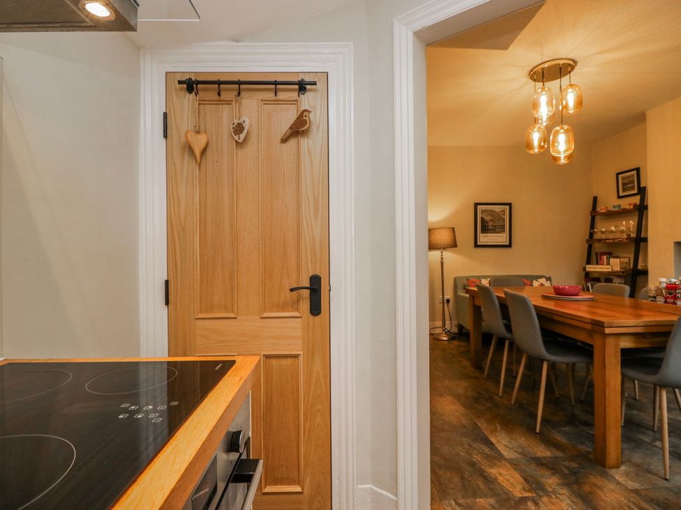 A kitchen with a door leading to a dining area at The Thistles Bowness-On-Windermere