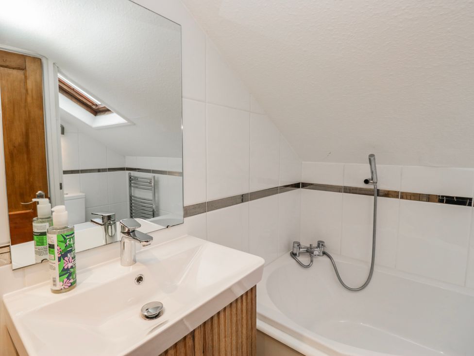A bathroom with a sink and bathtub at The Thistles Bowness-On-Windermere