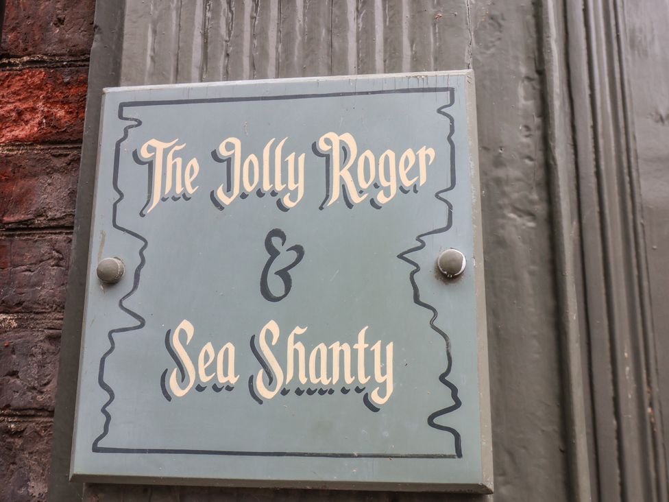 A sign for The Jolly Roger and Sea Shanty in Whitby
