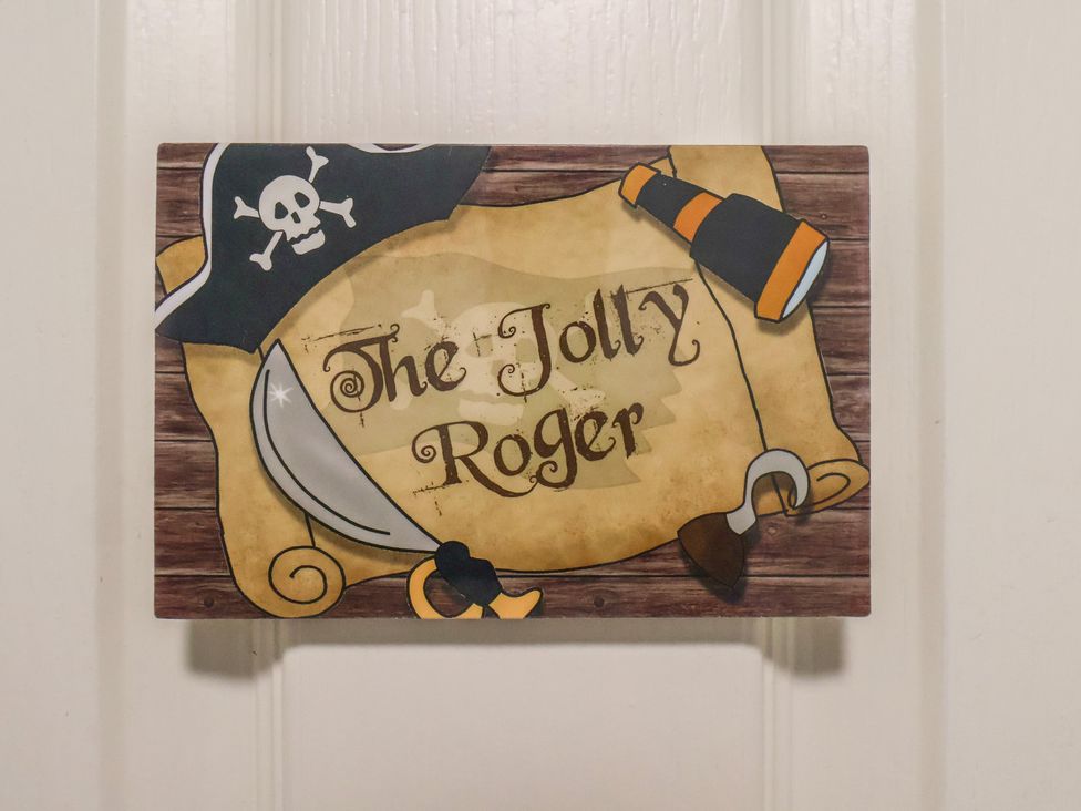 A decorative sign with pirate theme at Jolly Roger in Whitby