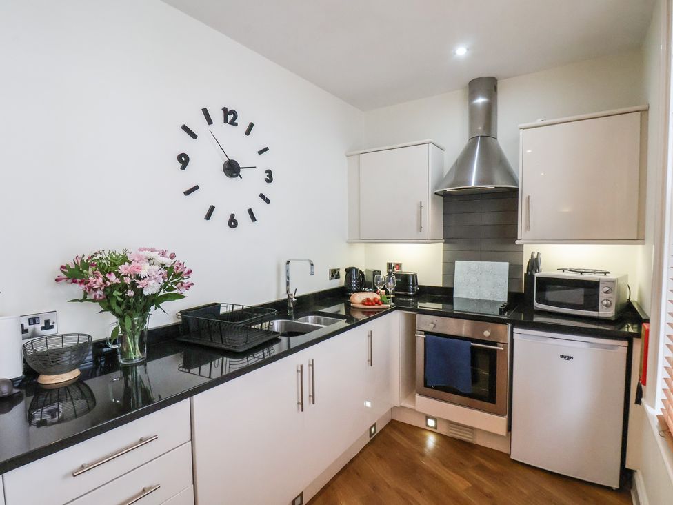 A kitchen with a sink and appliances at Jolly Roger in Whitby