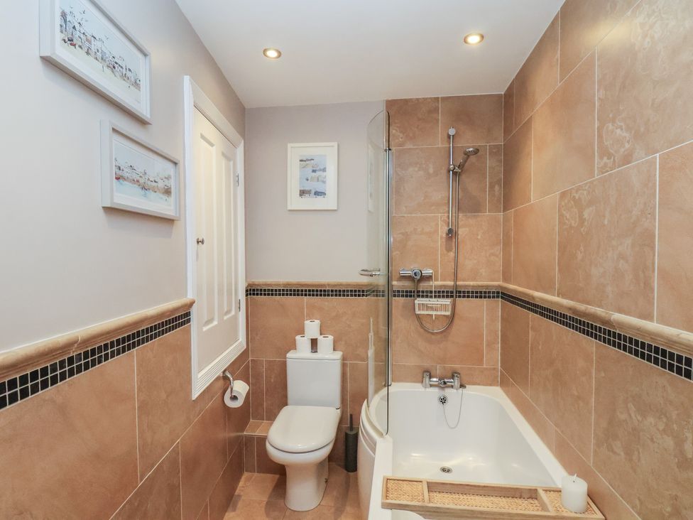 A bathroom with a shower, bathtub, and toilet at Jolly Roger in Whitby