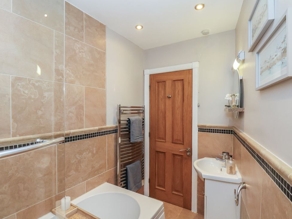 A bathroom with a bathtub and sink at Jolly Roger in Whitby