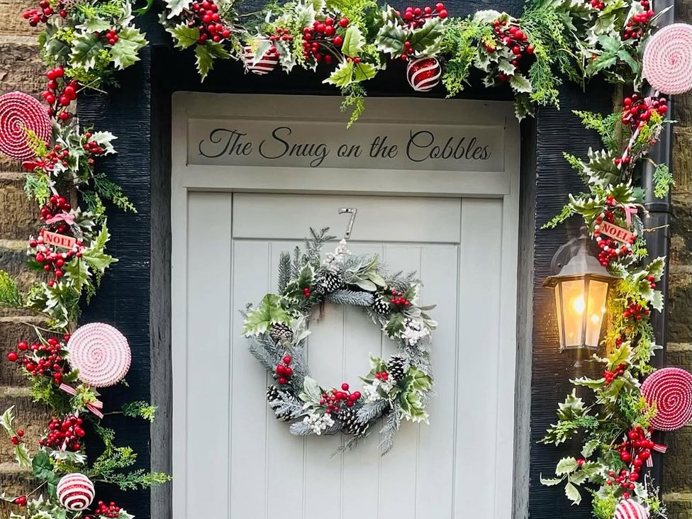 An entrance with a wreath and decorations at The Snug on the Cobbles in Haworth
