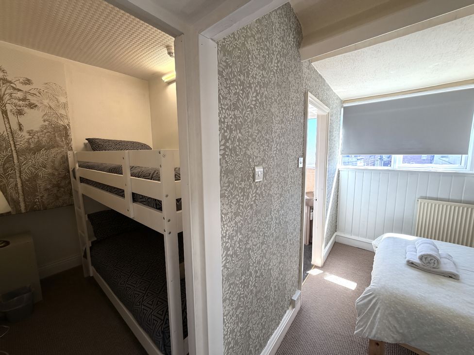 A bedroom with a bunk bed and a single bed at Avalon Lodge in Bridlington