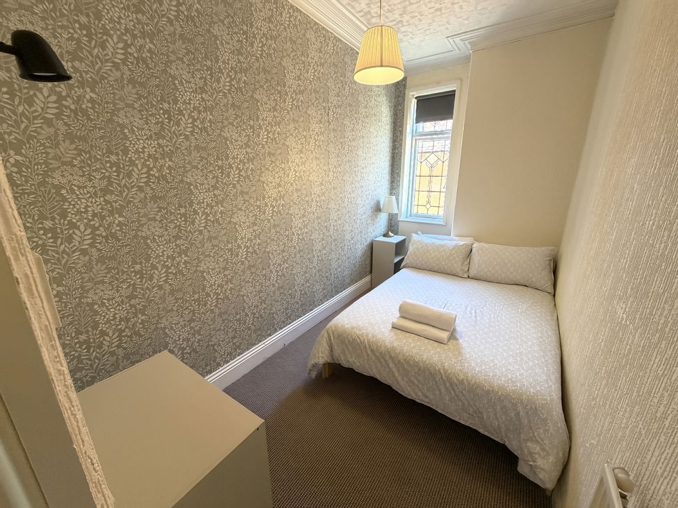 A bedroom with a bed and lamp at Avalon Lodge in Bridlington