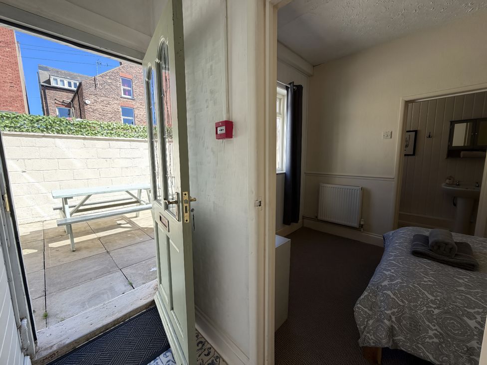 A doorway leading to a patio with a picnic table at Avalon Lodge in Bridlington
