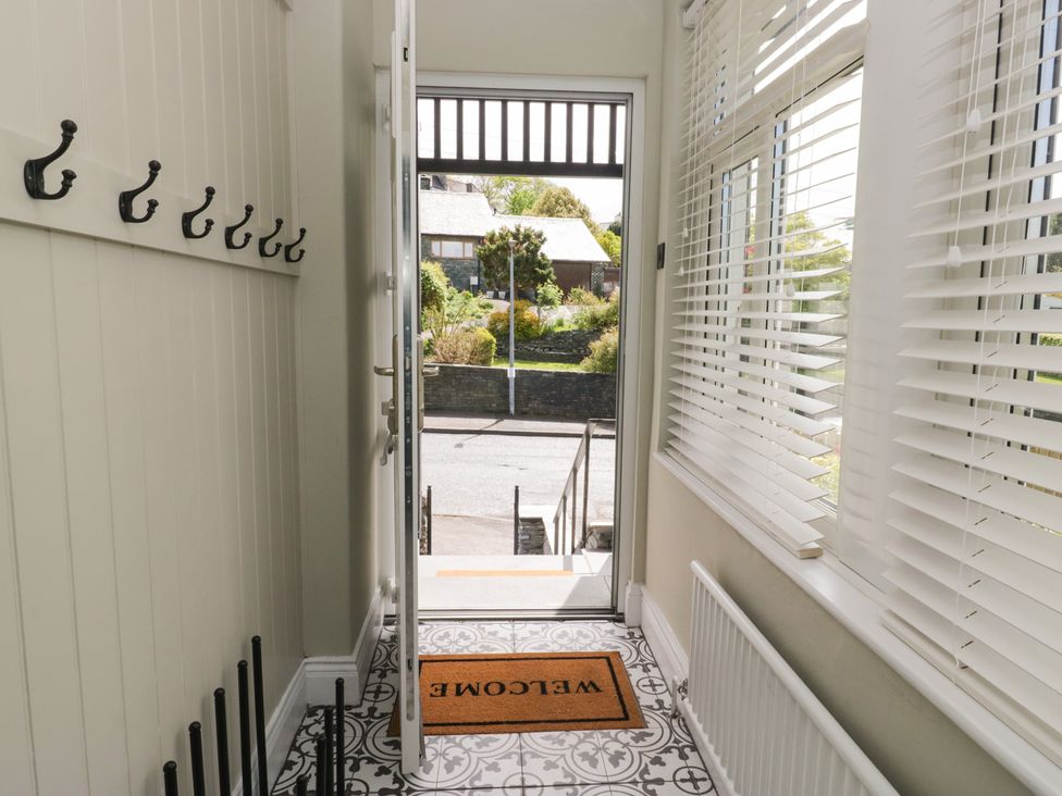 A hallway with hooks and a welcome mat at 5 Thornbarrow Road in 