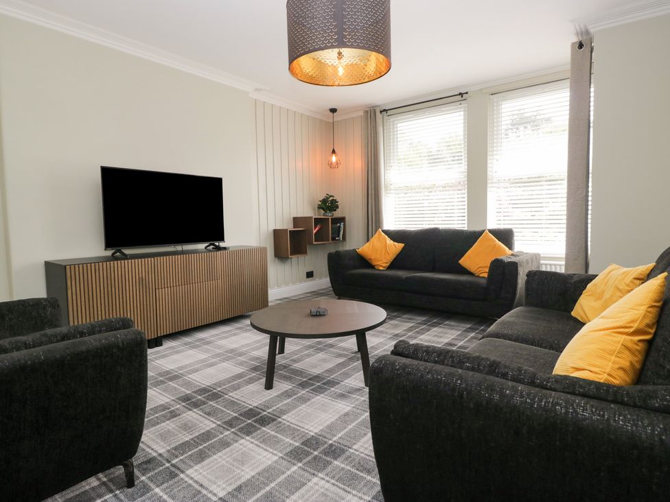 A living room with a television and a coffee table at 5 Thornbarrow Road