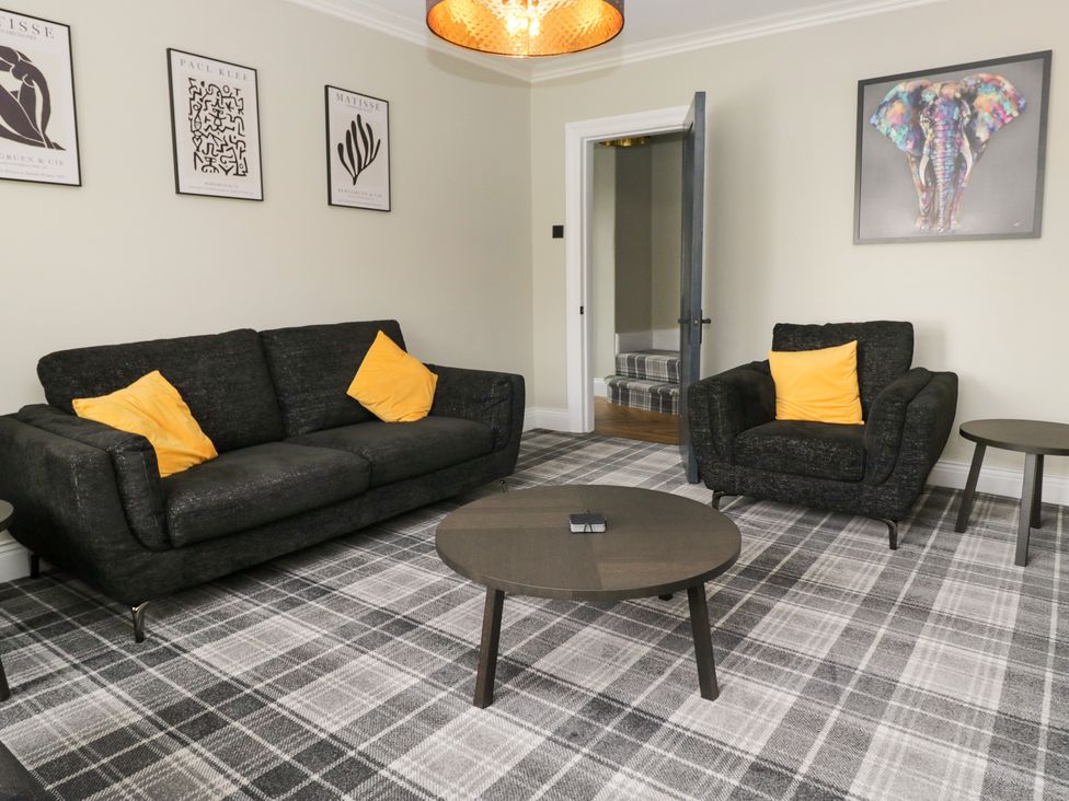 A living room with a sofa and armchair at 5 Thornbarrow Road