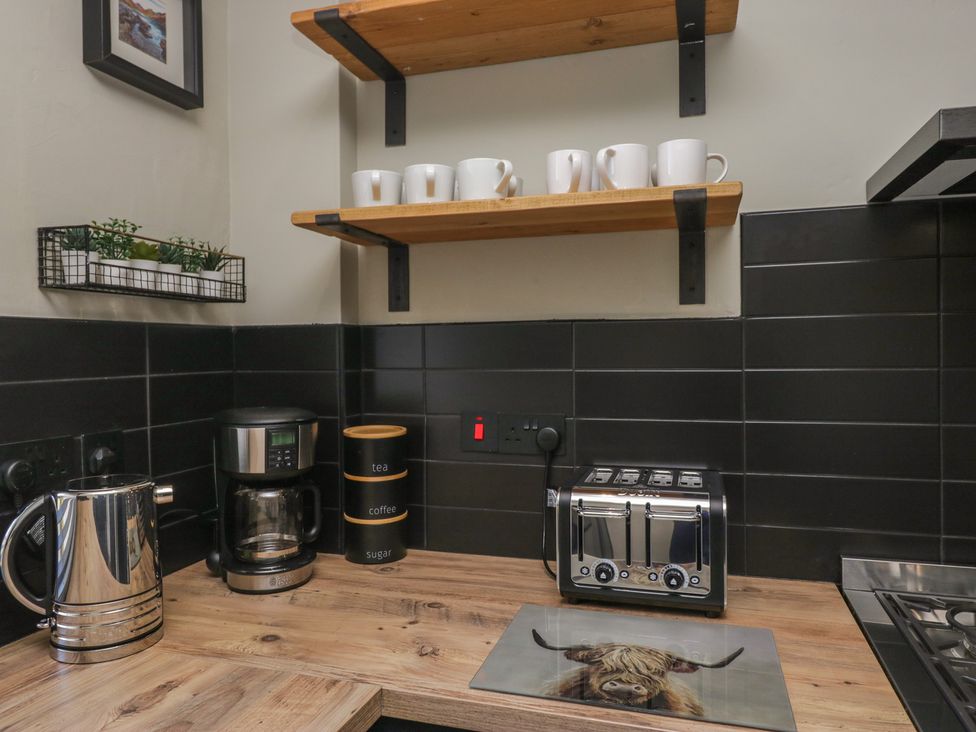 A kitchen area with a kettle, coffee maker, and toaster at 5 Thornbarrow Road