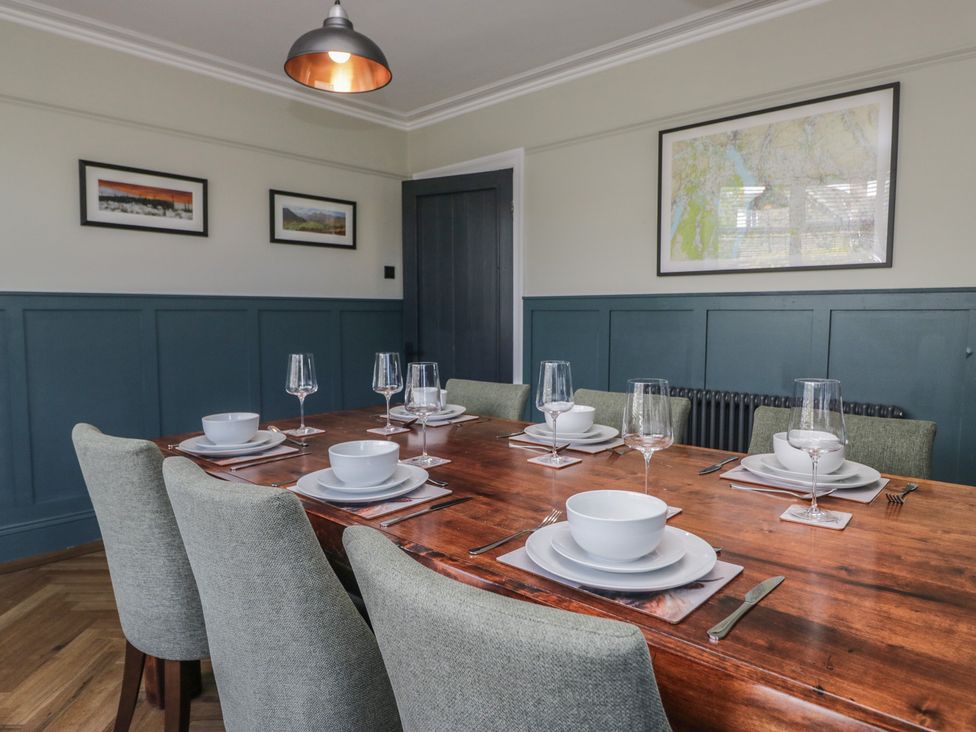 A dining room with a wooden table set for a meal at 5 Thornbarrow Road 