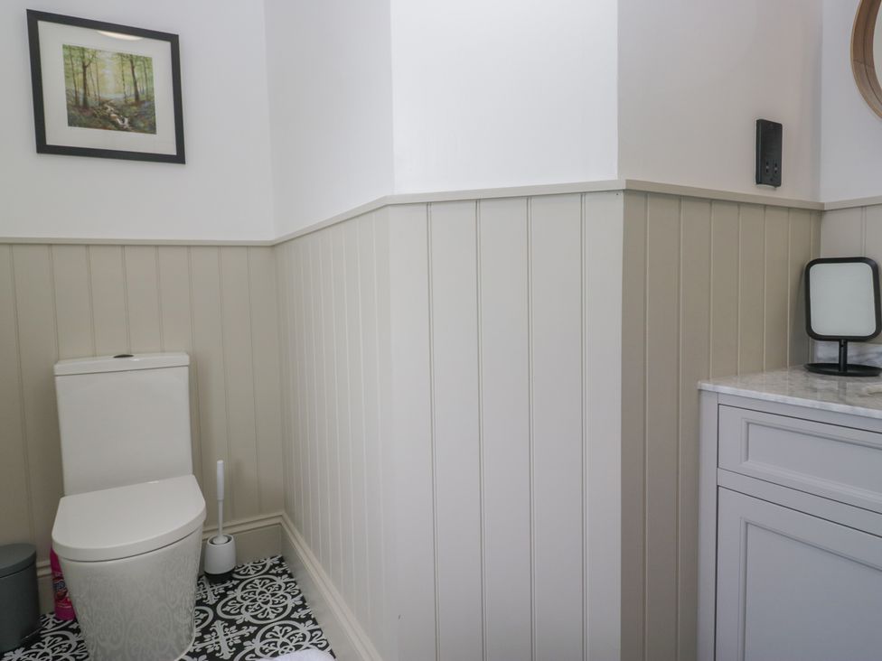 A bathroom with a toilet and sink at 5 Thornbarrow Road