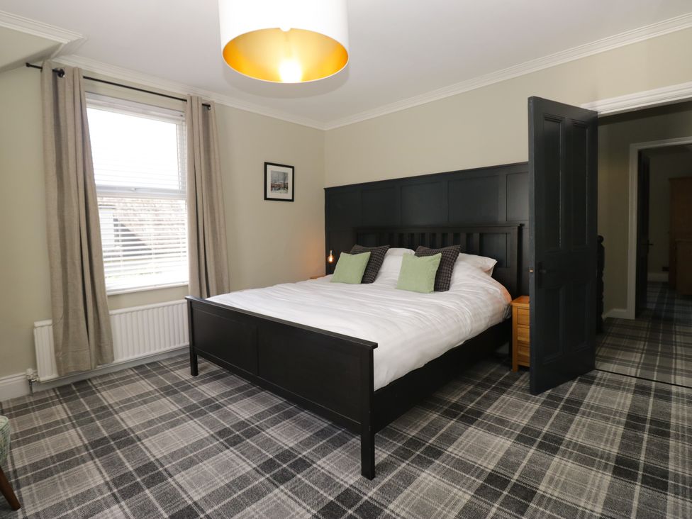 A bedroom with a bed and window at 5 Thornbarrow Road