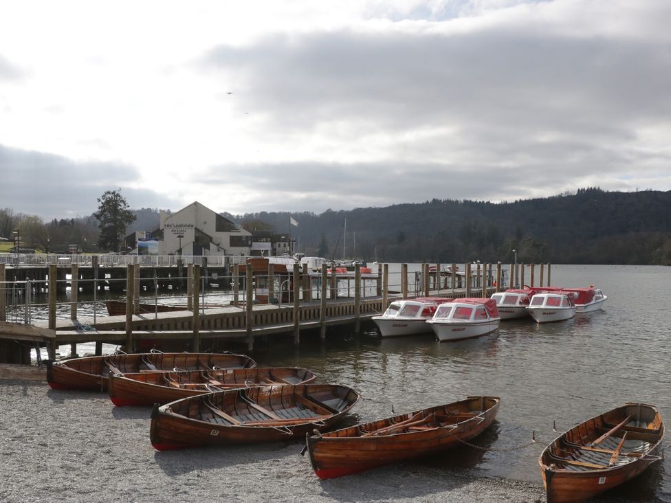 Wooden and motorboats at a pier with a building in the background at 5 Thornbarrow Road