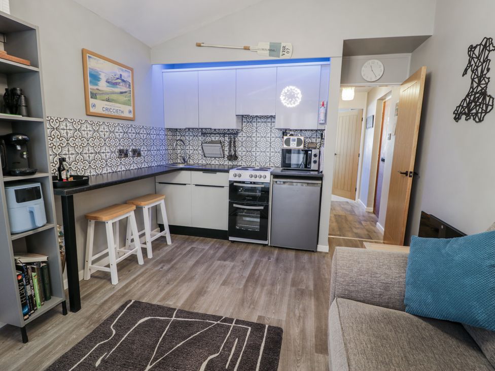 A kitchen with appliances and seating at Estuary Escape in Porthmadog