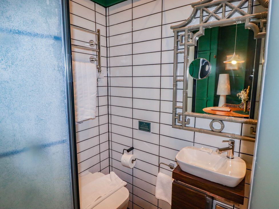 A bathroom with a sink and toilet at The Carriages St Athan
