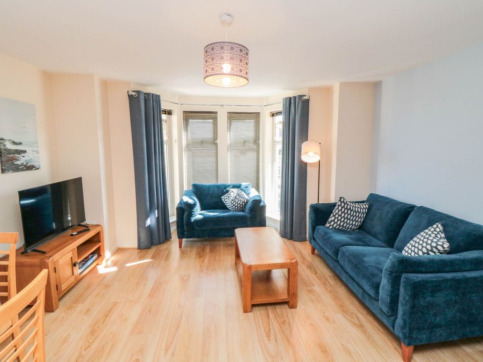 A living room with a television and seating area at Flat 17 in 