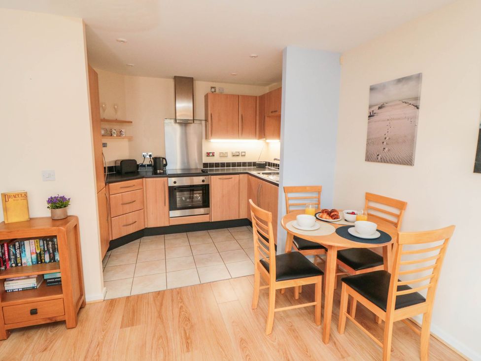 A kitchen with a dining table and chairs at Flat 17
