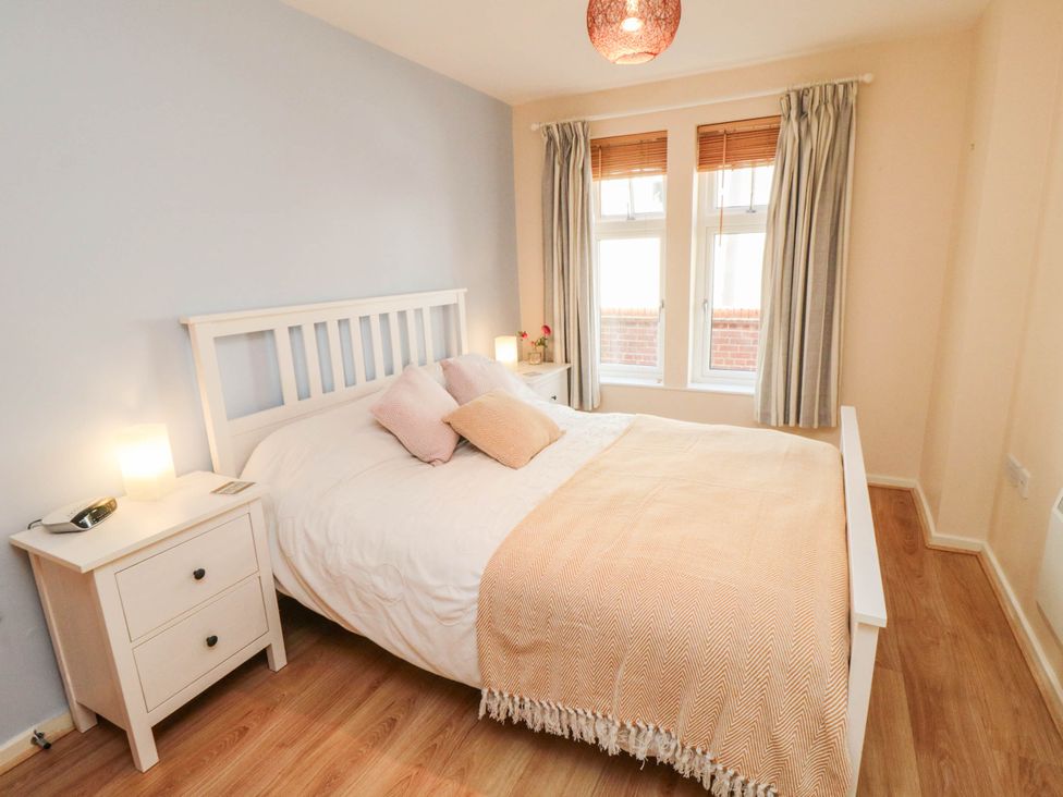 A bedroom with a bed and windows at Flat 17 in 