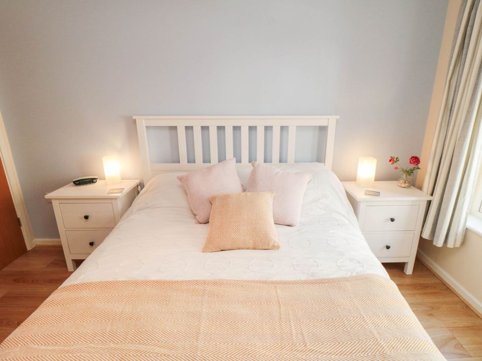 A bedroom with a bed and bedside tables at Flat 17