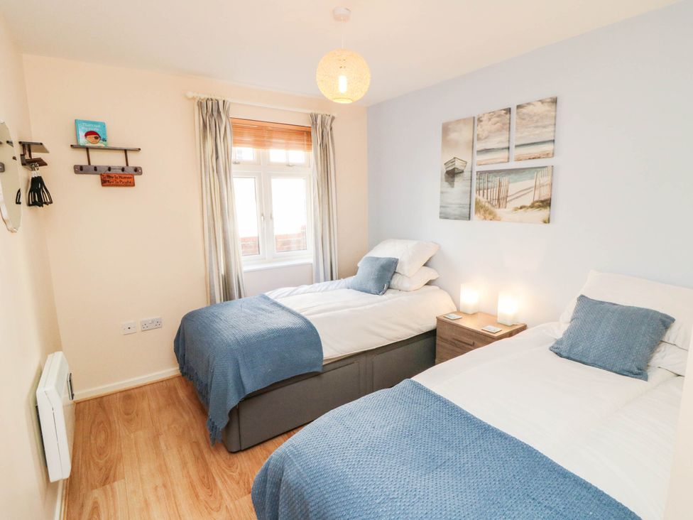 A bedroom with two beds and wall art at Flat 17 in 