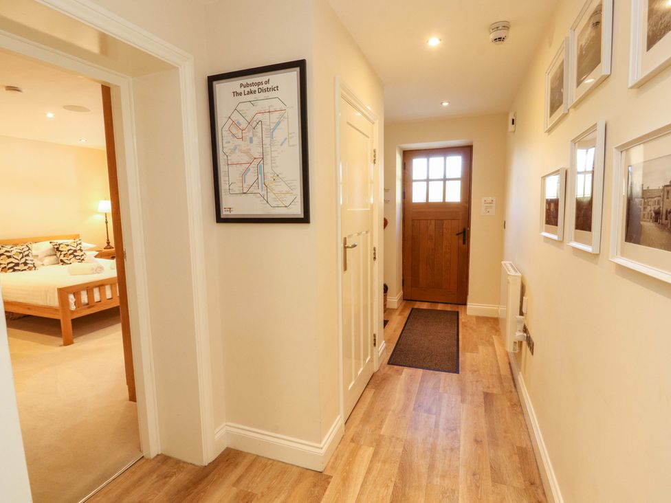 A hallway with a door and a map at Deer Wood At Applethwaite Hall in Windermere
