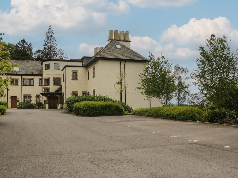A building with a parking lot and trees at Deer Wood At Applethwaite Hall Windermere