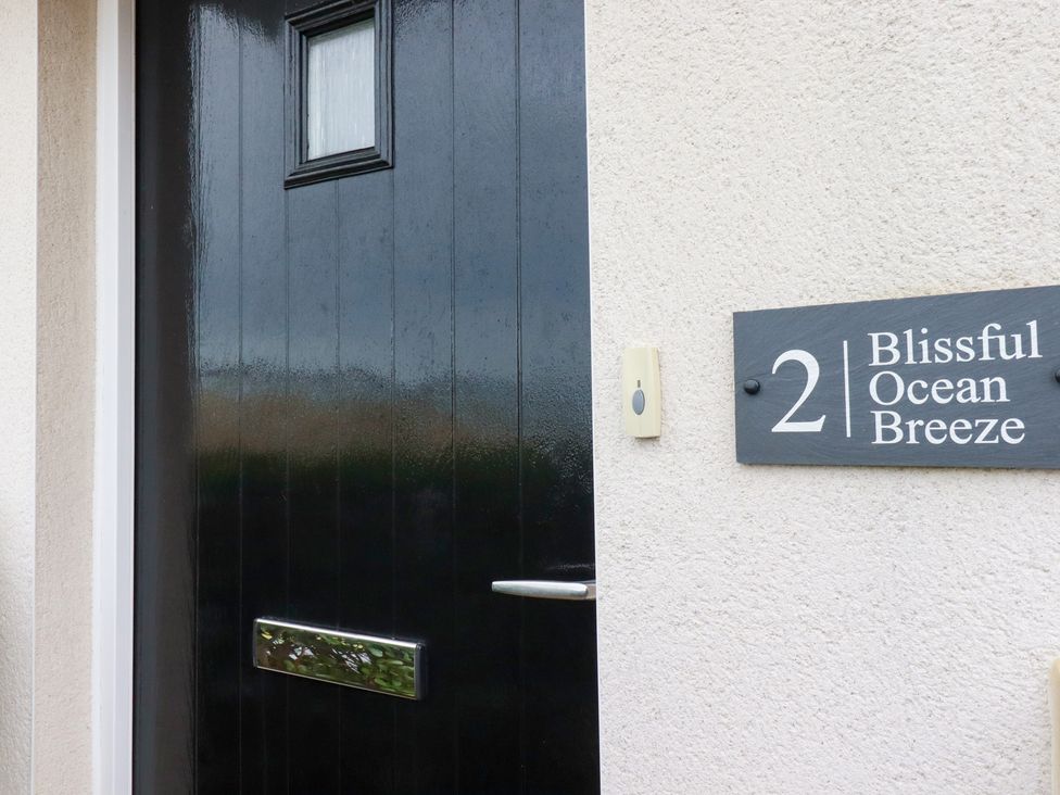 A front door with a sign at Blissful Ocean Breeze in Perranporth