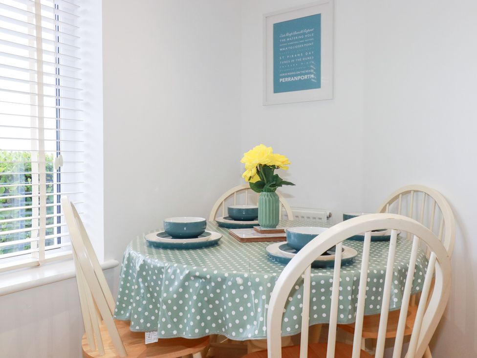 A dining room with a table and chairs at Blissful Ocean Breeze Perranporth