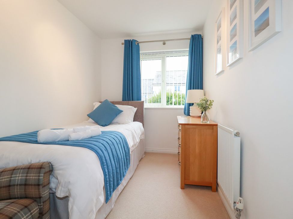 A bedroom with a bed and bedside table at Blissful Ocean Breeze in Perranporth