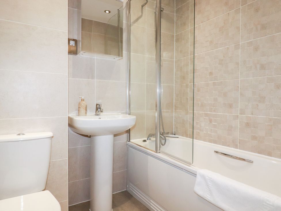 A bathroom with a sink, toilet, and bathtub at Blissful Ocean Breeze in Perranporth