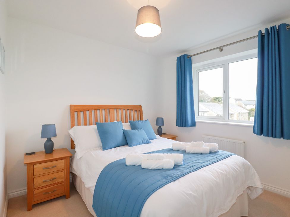 A bedroom with a bed and lamps at Blissful Ocean Breeze in Perranporth