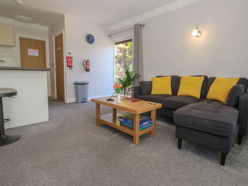 A living room with a table and sofa at Lake View, Swanpool, Nr Falmouth