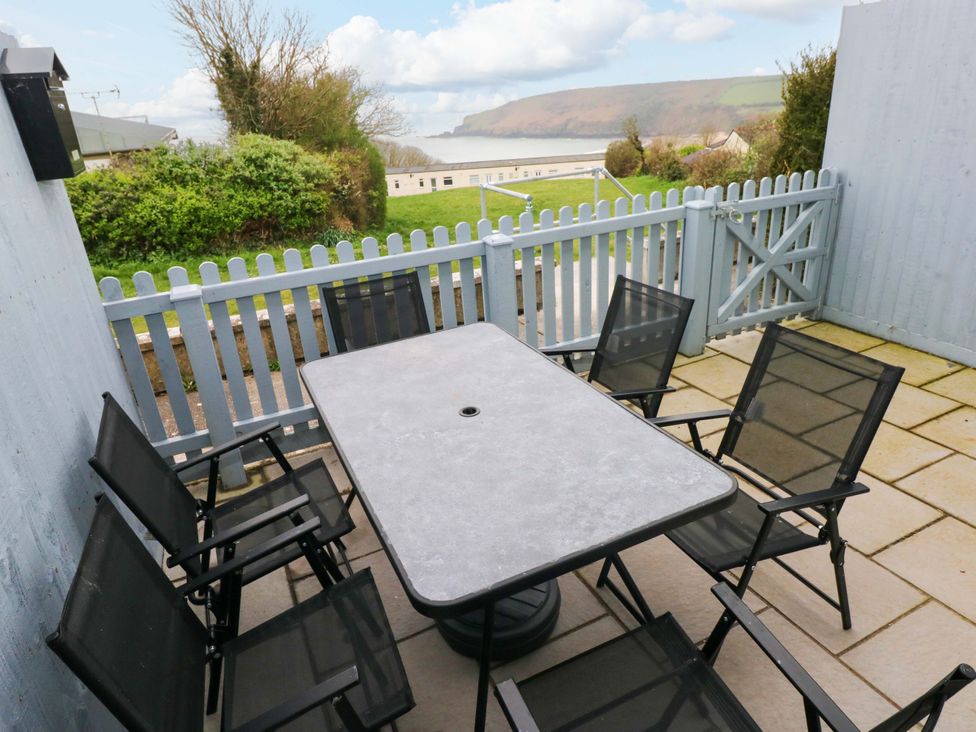 An outdoor patio with a table and chairs at 3 Devon Court in Pembroke