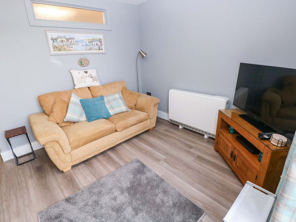 A living room with a sofa and television at 3 Devon Court in Pembroke