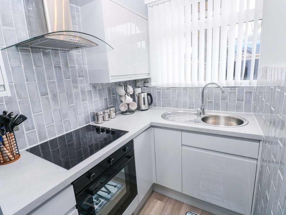 A kitchen with cabinets and appliances at 3 Devon Court in Pembroke
