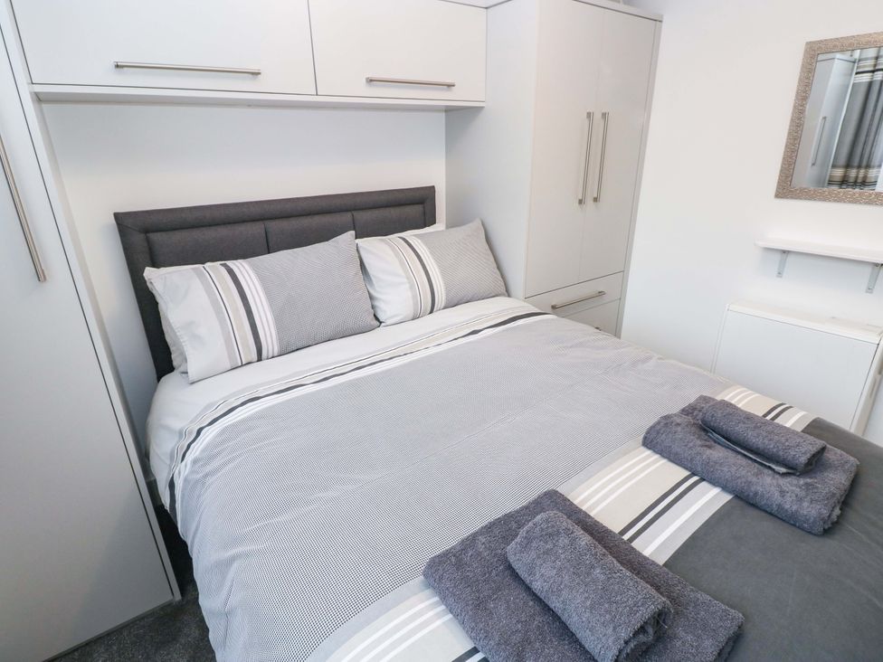 A bedroom with a bed and storage at 3 Devon Court Pembroke