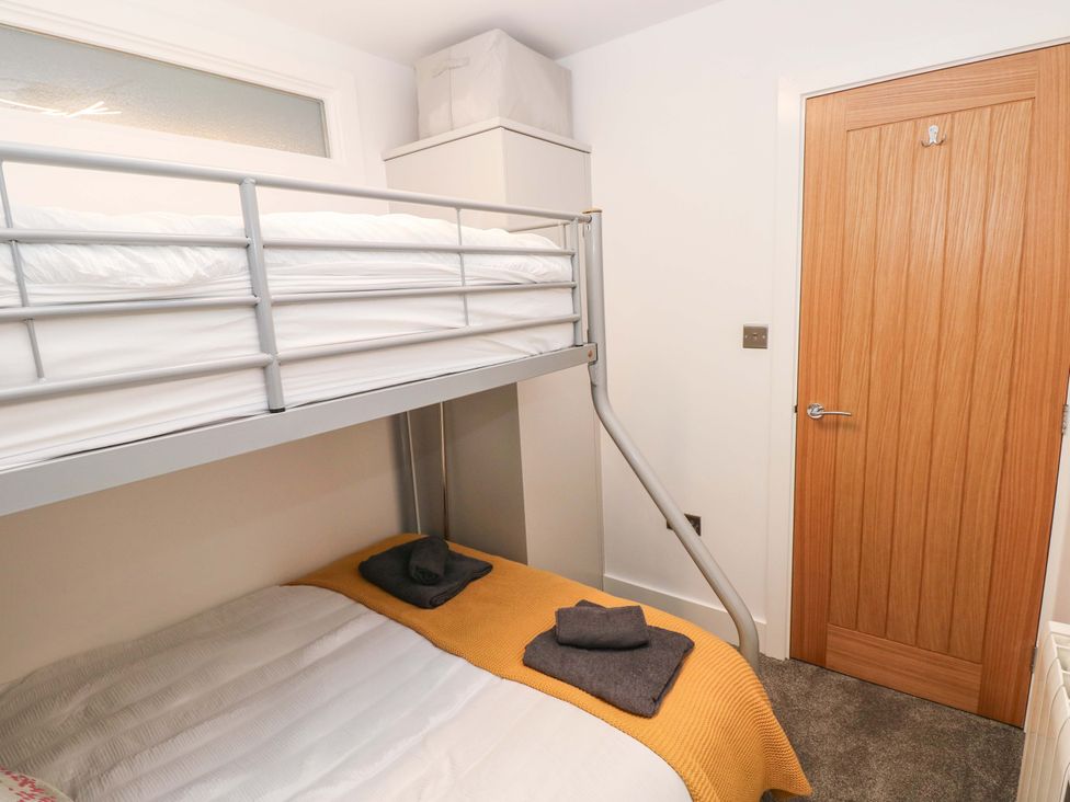 A bedroom with a bunk bed and double bed at 3 Devon Court in Pembroke
