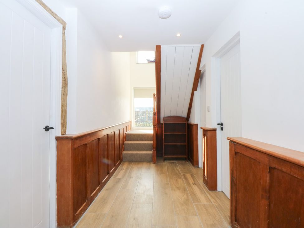 A hallway with a staircase and doors at Yr Hen Felin in Dyffryn Ardudwy
